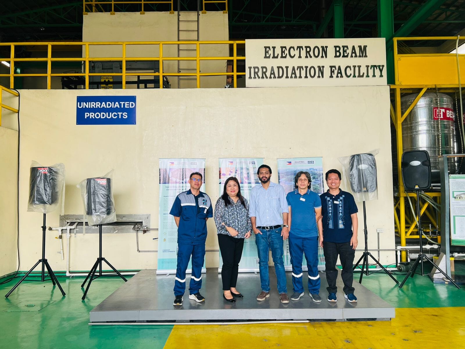 Team photo at the facility with industrial equipment